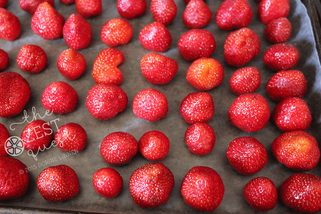 Strawberries-hulled-cleaned-and-on-wax-paper-to-freeze-and-bag-2-The-Zest-Quest