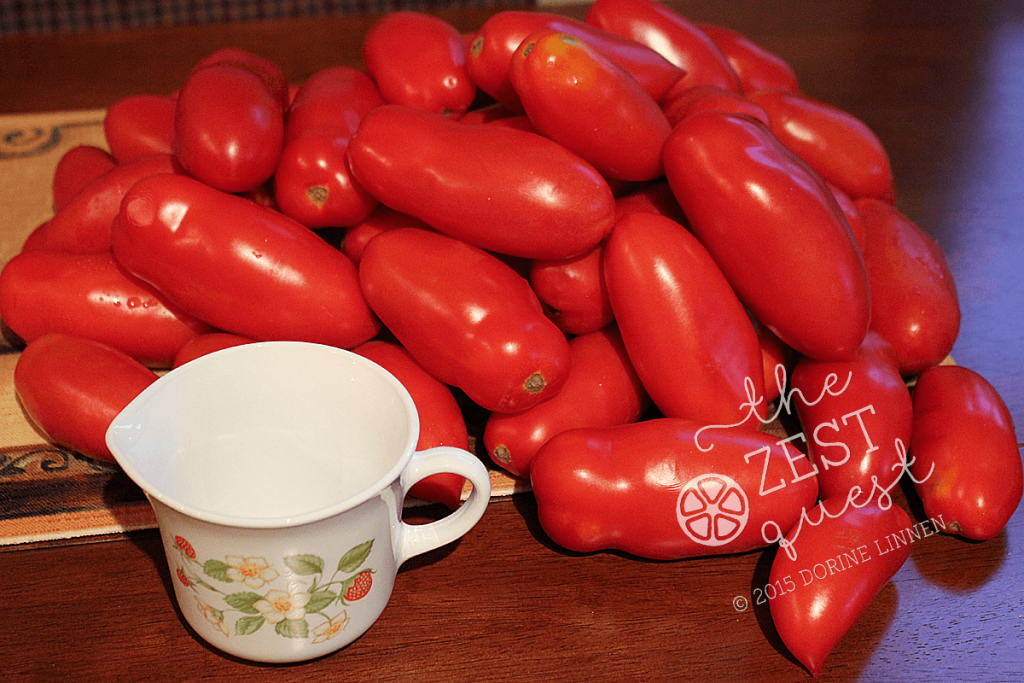 Ohio-Farm-Share-Week-15-one-quarter-bushel-San-Marzano-Tomatoes-pile-compared-to-a-cup-2-The-Zest-Qest